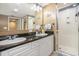 Bathroom boasts dual sinks, a granite countertop, a large mirror, and a tiled stand-up shower at 2151 Bridge Ct. # 1-305, North Myrtle Beach, SC 29582