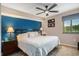 Bedroom showcases a large bed with a blue accent wall and a ceiling fan at 2151 Bridge Ct. # 1-305, North Myrtle Beach, SC 29582