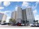 Condo building with balconies in a nice day with parking and palm trees at 2151 Bridge Ct. # 1-305, North Myrtle Beach, SC 29582