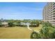 Beautifully landscaped property with green grass, palm trees and large outdoor pool at 2151 Bridge Ct. # 1-305, North Myrtle Beach, SC 29582