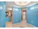 Hallway featuring blue walls, tile floors, and appliances at 2151 Bridge Ct. # 1-305, North Myrtle Beach, SC 29582
