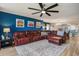 Bright living room featuring a large sofa and a ceiling fan at 2151 Bridge Ct. # 1-305, North Myrtle Beach, SC 29582