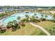 Aerial view of a large community pool with a poolside bar and lush landscaping overlooking a serene waterway at 2151 Bridge Ct. # 1-305, North Myrtle Beach, SC 29582