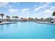 Resort-style outdoor pool with palm trees, lounge chairs and a bar area at 2151 Bridge Ct. # 1-305, North Myrtle Beach, SC 29582