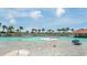 Large community pool featuring a zero entry access, seating areas, and palm trees, perfect for relaxation at 2151 Bridge Ct. # 1-305, North Myrtle Beach, SC 29582