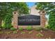 Elegant brick-framed sign for Yacht Club Villas, surrounded by neatly manicured landscaping and colorful flower beds at 2151 Bridge Ct. # 1-305, North Myrtle Beach, SC 29582