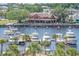 Picturesque waterfront dining with boat docks and a view of a restaurant surrounded by lush trees and tropical palms at 2151 Bridge Ct. # 1-305, North Myrtle Beach, SC 29582