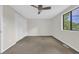 Carpeted bedroom featuring a fan, window and a built in closet with white doors at 217 N Myrtle St. # 1, Myrtle Beach, SC 29577