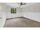 Neutral bedroom with plush carpet, ceiling fan, and ample natural light at 217 N Myrtle St. # 1, Myrtle Beach, SC 29577