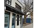 Charming exterior with eye-catching blue doors, modern black window frames, and tasteful facade lighting at 217 N Myrtle St. # 1, Myrtle Beach, SC 29577