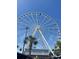 The Myrtle Beach SkyWheel is a breathtaking Ferris wheel with panoramic ocean views set against a vibrant blue sky at 217 N Myrtle St. # 1, Myrtle Beach, SC 29577