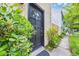 Inviting front door with decorative window, surrounded by lush greenery at 217 N Myrtle St. # 1, Myrtle Beach, SC 29577