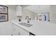 Bright kitchen with stainless steel sink, white cabinets, and quartz countertops at 217 N Myrtle St. # 1, Myrtle Beach, SC 29577