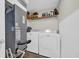 Functional laundry room with washer, dryer, and shelving for storage at 217 N Myrtle St. # 1, Myrtle Beach, SC 29577