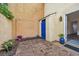Cozy brick patio with stucco walls, lush greenery, and a blue gate at 217 N Myrtle St. # 1, Myrtle Beach, SC 29577