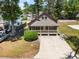 Aerial view of home with a long driveway and a covered porch at 2191 Liberty Circle, Little River, SC 29566
