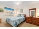 Bright bedroom with a blue floral comforter, dresser, and natural light at 2191 Liberty Circle, Little River, SC 29566