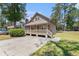 View of home with manicured lawn and large trees surrounding at 2191 Liberty Circle, Little River, SC 29566