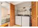 Laundry room with washer, dryer, and storage, next to additional bedroom at 2191 Liberty Circle, Little River, SC 29566