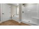 Bathroom featuring a soaking tub, shower, wood floors, and neutral paint at 2260 Pearl Rd., Galivants Ferry, SC 29544