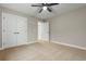 Bedroom featuring plush carpet, neutral walls, ceiling fan, closet, and doorway to hallway at 2260 Pearl Rd., Galivants Ferry, SC 29544