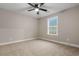 Bright bedroom with neutral walls, plush carpet, and a large window at 2260 Pearl Rd., Galivants Ferry, SC 29544