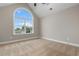 Bedroom featuring plush carpet, neutral walls, ceiling fan, and a large arched window at 2260 Pearl Rd., Galivants Ferry, SC 29544