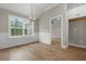 An elegant dining area featuring wood floors, wainscotting, and natural light from the windows at 2260 Pearl Rd., Galivants Ferry, SC 29544