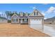 Charming two-story home featuring a brick facade, arched window and a two-car garage at 2260 Pearl Rd., Galivants Ferry, SC 29544