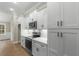 Modern kitchen with white cabinets, stainless steel appliances, and wood flooring at 2260 Pearl Rd., Galivants Ferry, SC 29544