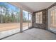 Screened patio with brick wall and views of the natural backyard landscape at 2260 Pearl Rd., Galivants Ferry, SC 29544