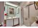 Well-lit bathroom with a vanity, decorative mirror and a glass-enclosed shower at 24 Frigate Ct., Pawleys Island, SC 29585