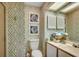Nautical-themed bathroom featuring patterned wallpaper, a vanity, and coordinating decor at 24 Frigate Ct., Pawleys Island, SC 29585