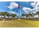 Beautifully landscaped community clubhouse featuring vibrant flowers and palm trees, creating a welcoming and picturesque atmosphere at 24 Frigate Ct., Pawleys Island, SC 29585