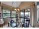 Dining area with a large glass table, stylish seating, and views of the outdoor scenery at 24 Frigate Ct., Pawleys Island, SC 29585