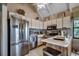 Bright kitchen with stainless steel appliances, white cabinetry, and an eat-in counter at 24 Frigate Ct., Pawleys Island, SC 29585