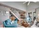Living room area with high ceilings, open staircase, and views into the kitchen at 24 Frigate Ct., Pawleys Island, SC 29585