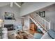 Bright living room features high ceilings, fireplace, and staircase leading to a loft area at 24 Frigate Ct., Pawleys Island, SC 29585