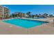 Expansive pool area featuring clear turquoise water and lounge seating, perfect for relaxation and enjoying the sunny weather at 24 Frigate Ct., Pawleys Island, SC 29585