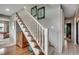 Staircase with white railing, wood treads, and stylish decor on the wall at 24 Frigate Ct., Pawleys Island, SC 29585