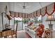 Bright sunroom with comfortable seating, desk and a beautiful view of the water at 24 Frigate Ct., Pawleys Island, SC 29585