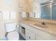 Bathroom featuring a single sink vanity, toilet, mirror and walk-in shower at 2511 S Ocean Blvd. S # 1802B, Myrtle Beach, SC 29577