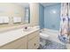 Traditional bathroom with a single sink vanity, toilet, tub and blue tiles at 2511 S Ocean Blvd. S # 1802B, Myrtle Beach, SC 29577