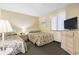 Traditional bedroom with two twin beds, window with blinds, lamp, nightstand and tv at 2511 S Ocean Blvd. S # 1802B, Myrtle Beach, SC 29577