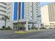 The Regency Towers features attractive landscaping at the entrance and an American flag at 2511 S Ocean Blvd. S # 1802B, Myrtle Beach, SC 29577
