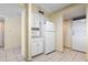 Functional kitchen with essential appliances and white cabinets, plus a laundry area at 2511 S Ocean Blvd. S # 1802B, Myrtle Beach, SC 29577