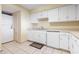 Kitchen featuring white cabinets, tile floors, dishwasher, sink, and in-unit laundry at 2511 S Ocean Blvd. S # 1802B, Myrtle Beach, SC 29577