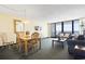 Relaxing living and dining area with cozy furniture and stunning ocean views from sliding doors at 2511 S Ocean Blvd. S # 1802B, Myrtle Beach, SC 29577