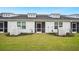 A well-maintained backyard with lush green grass and a screened-in porch area for outdoor enjoyment at 253 Bent Green Ct. # 70D, Murrells Inlet, SC 29576