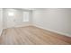 Bright living room with wood-look flooring and a white door at 253 Bent Green Ct. # 70D, Murrells Inlet, SC 29576